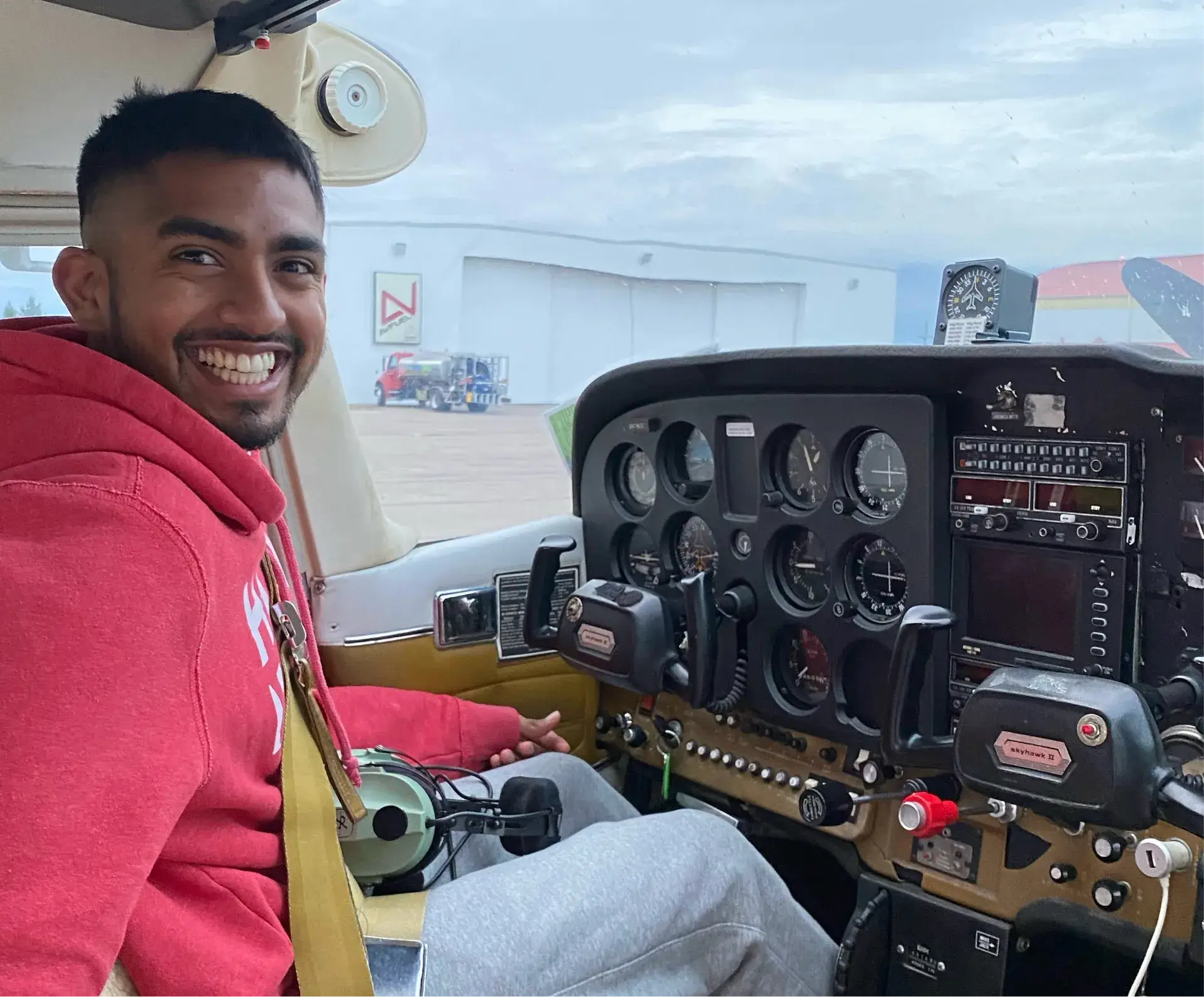 Smiling student pilot sitting in an aircraft cockpit during flight training